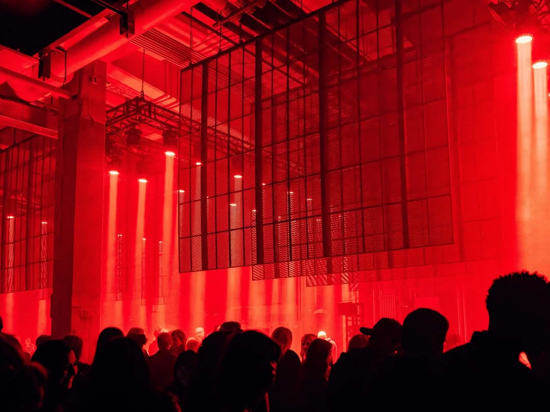 Art Club Houston at night — the room under red light with the LED mesh wall above the crowd