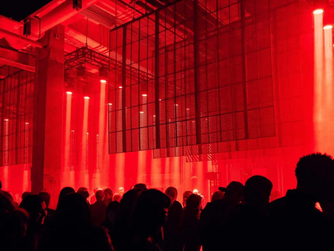 Art Club Houston at night — the room under red light with the LED mesh wall above the crowd